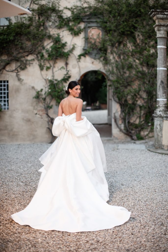 Elegant bride in flowing gown, dreamy romantic photo in fine art wedding style at Villa Catignano, Italy.