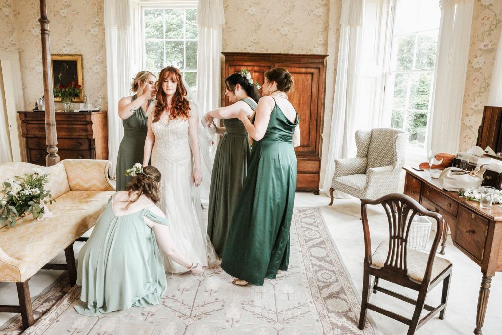 Bride and her bridal party getting ready for he wedding in bridal suite at Drenagh estate