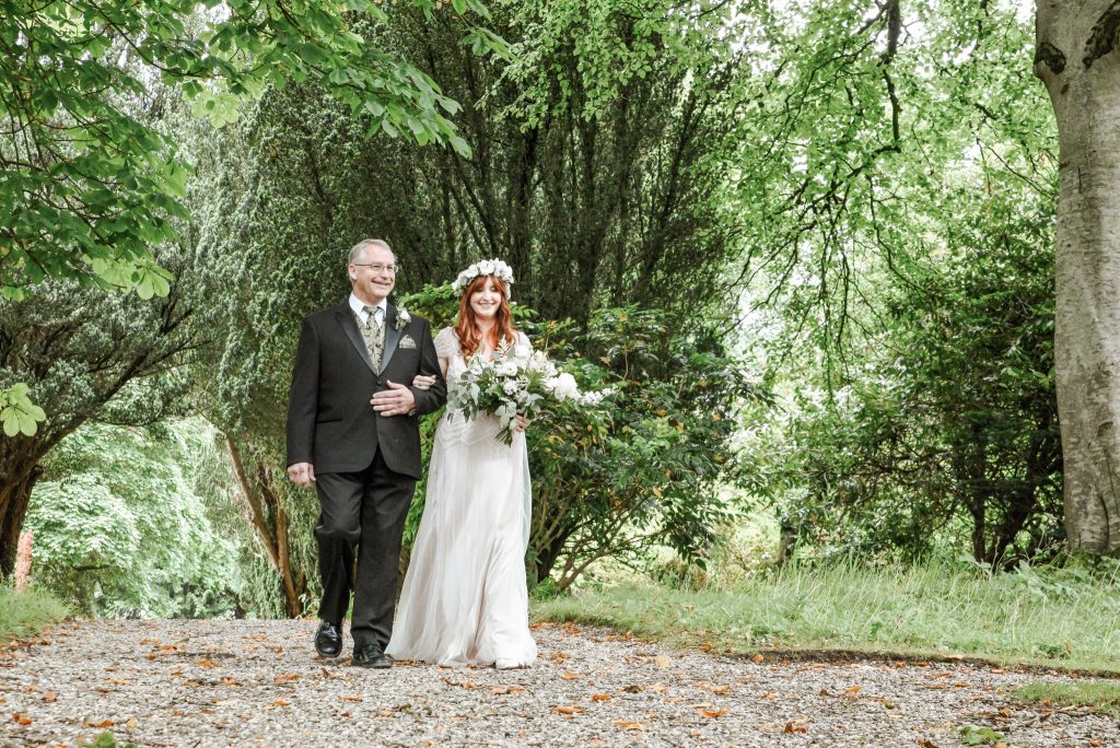 Father walking bride to the during romantic wedding ceremony at Drenagh Estate
