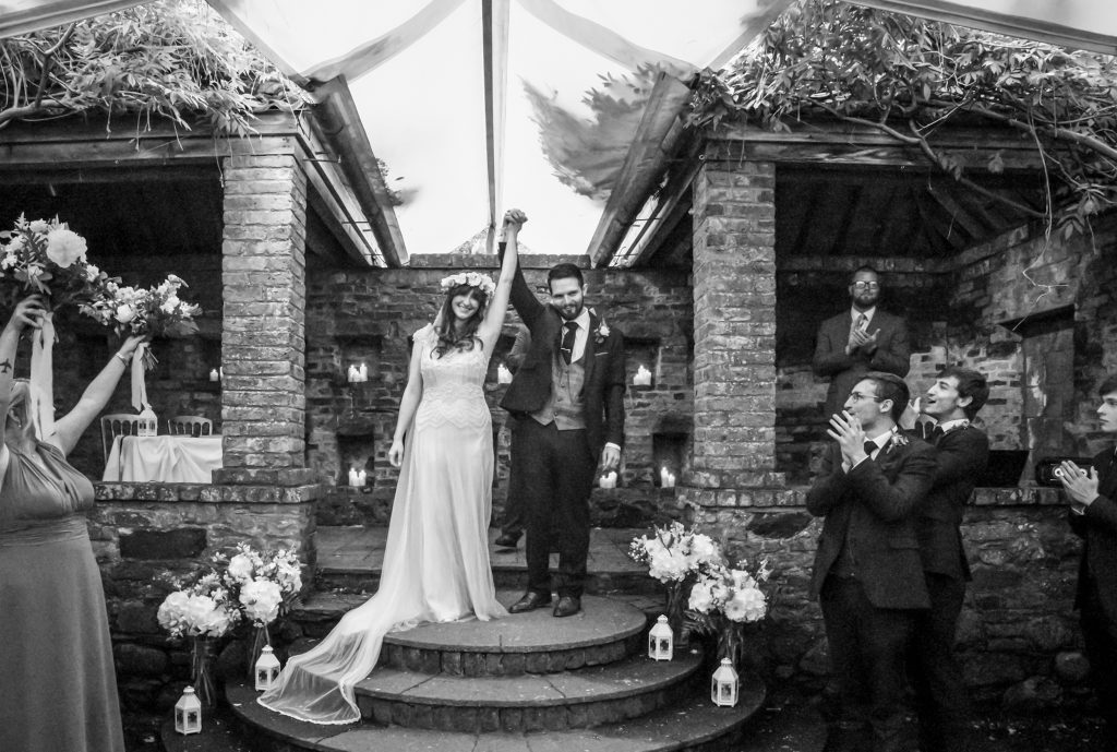 Bride and groom celebrating the special moment of just being married at Moon garden at Drenagh estate