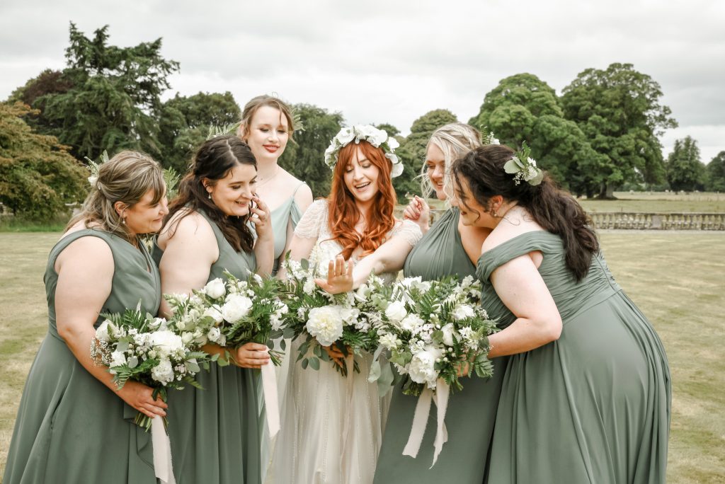 Bride showing wedding ring to bridesmaids in natural light at Drenagh Estate wedding