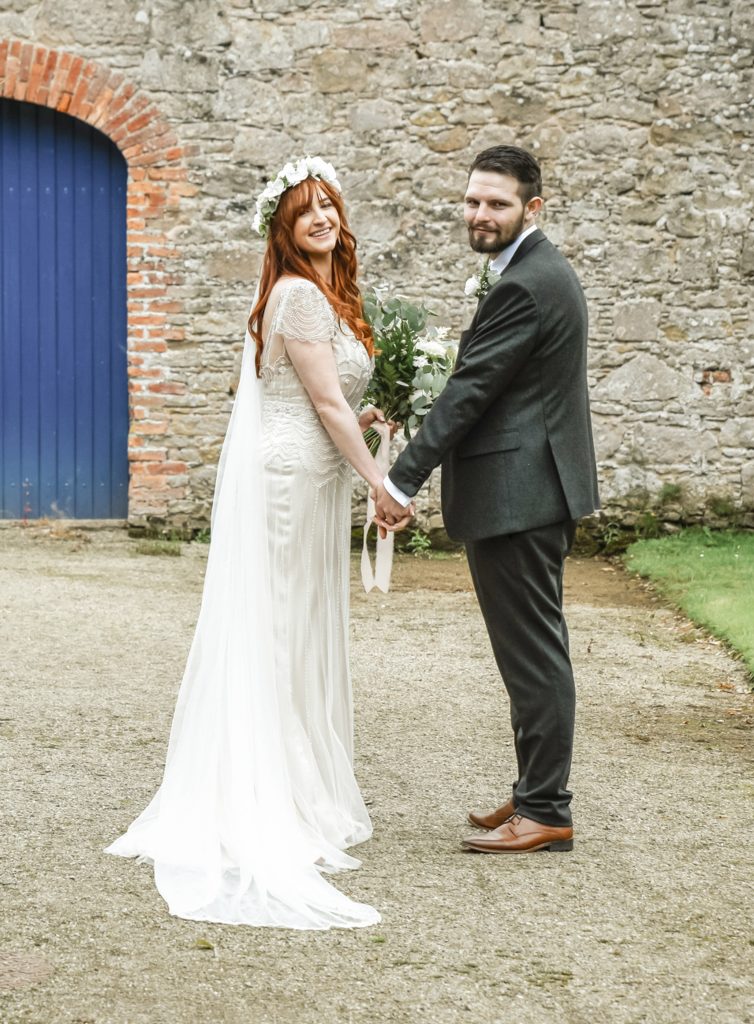 Bride and groom walking through the gardens at Drenagh Estate during their wedding in Northern Ireland