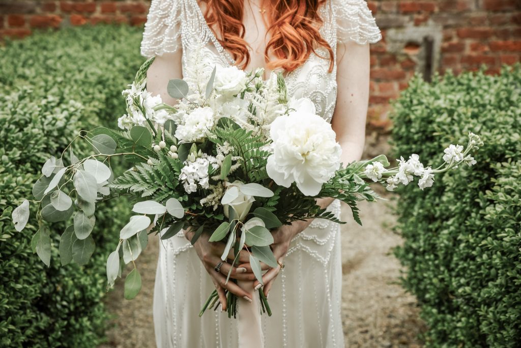 Bride holding a beautiful bridal bouquet in the gardens of the Drenagh estate