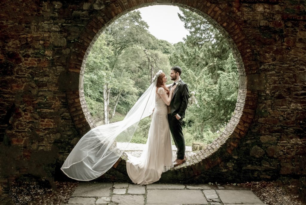 Bride and groom celebrating the special moment of just being married at Moon garden at Drenagh estate
