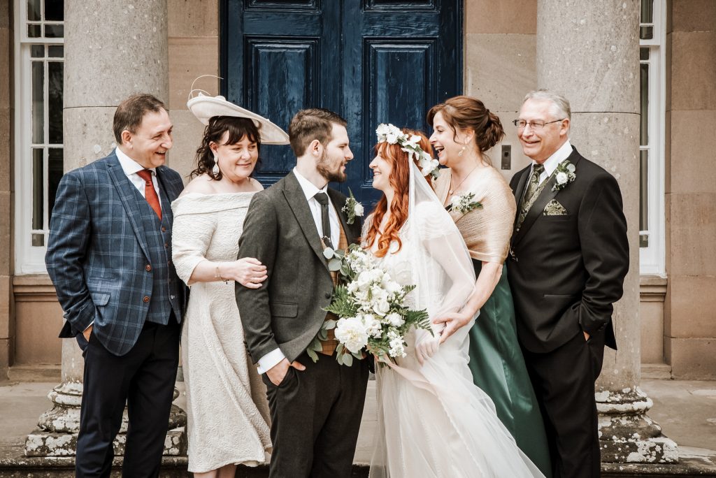 Bride and groom posing with parents during wedding at Drenagh House Estate in Northern Ireland