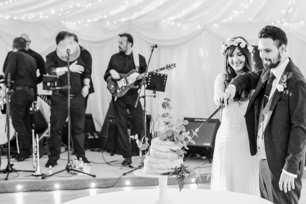 Bride and groom cutting the vegan wedding cake at Drenagh Estate wedding marquee