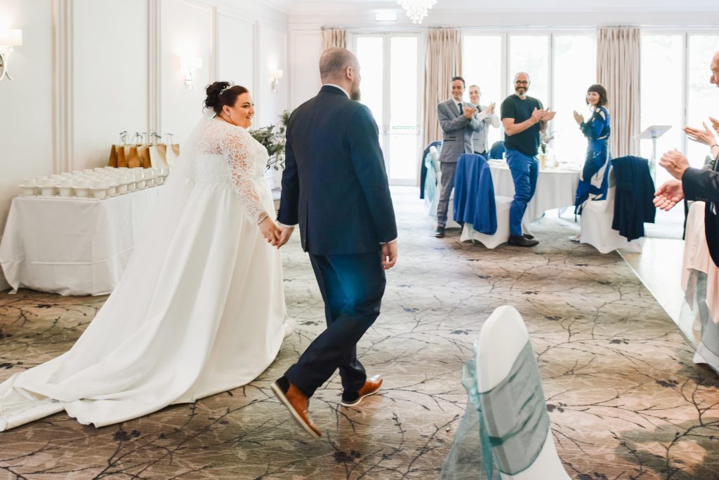 Bride and groom grand entrance during romantic wedding portraits in Northern Ireland Millbrook Lodge Ballynahinch