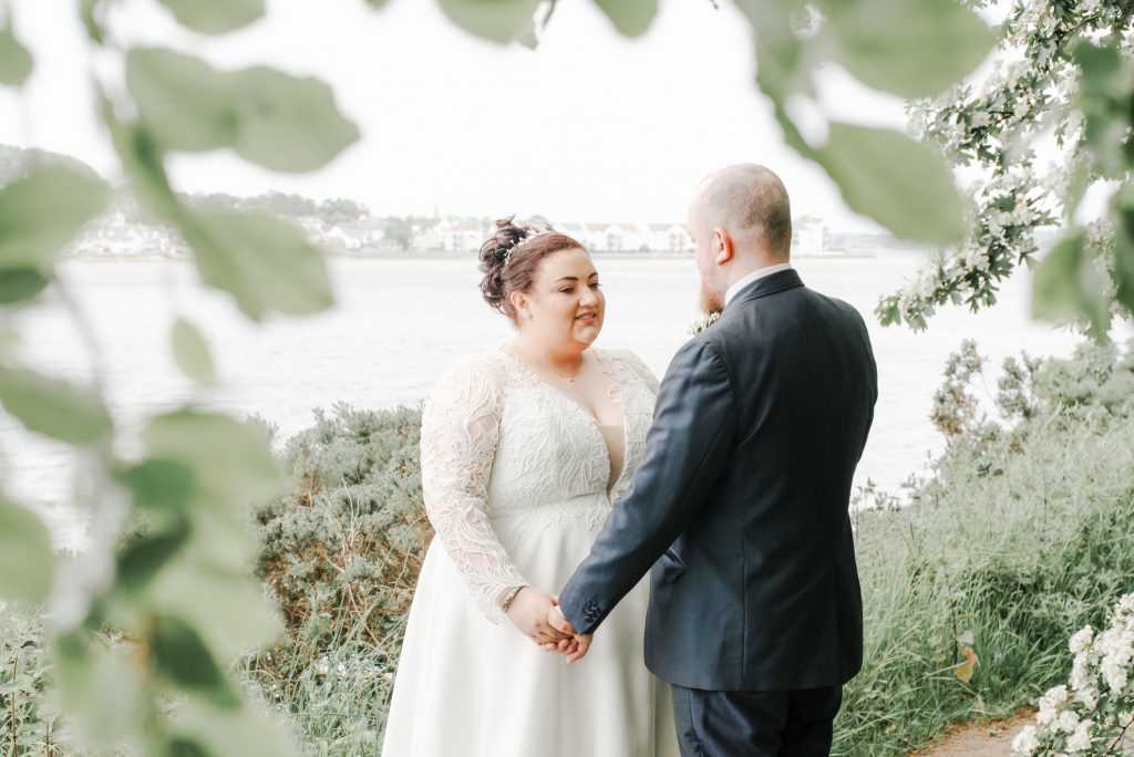Bride and groom embracing during romantic wedding portraits in Northern Ireland Dundrum