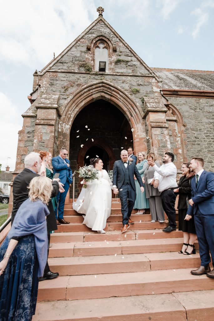 Newlyweds leaving St Donard’s Community Church after wedding ceremony