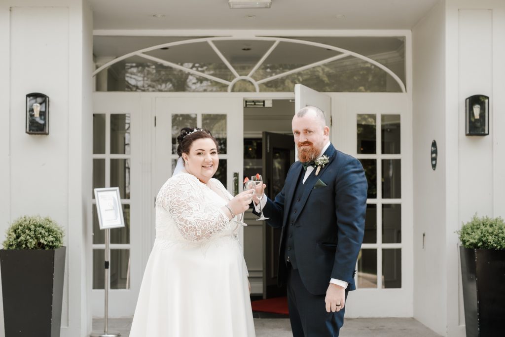 Bride and groom enjoying drinks during romantic wedding portraits in Northern Ireland Millbrook Lodge Ballynahinch