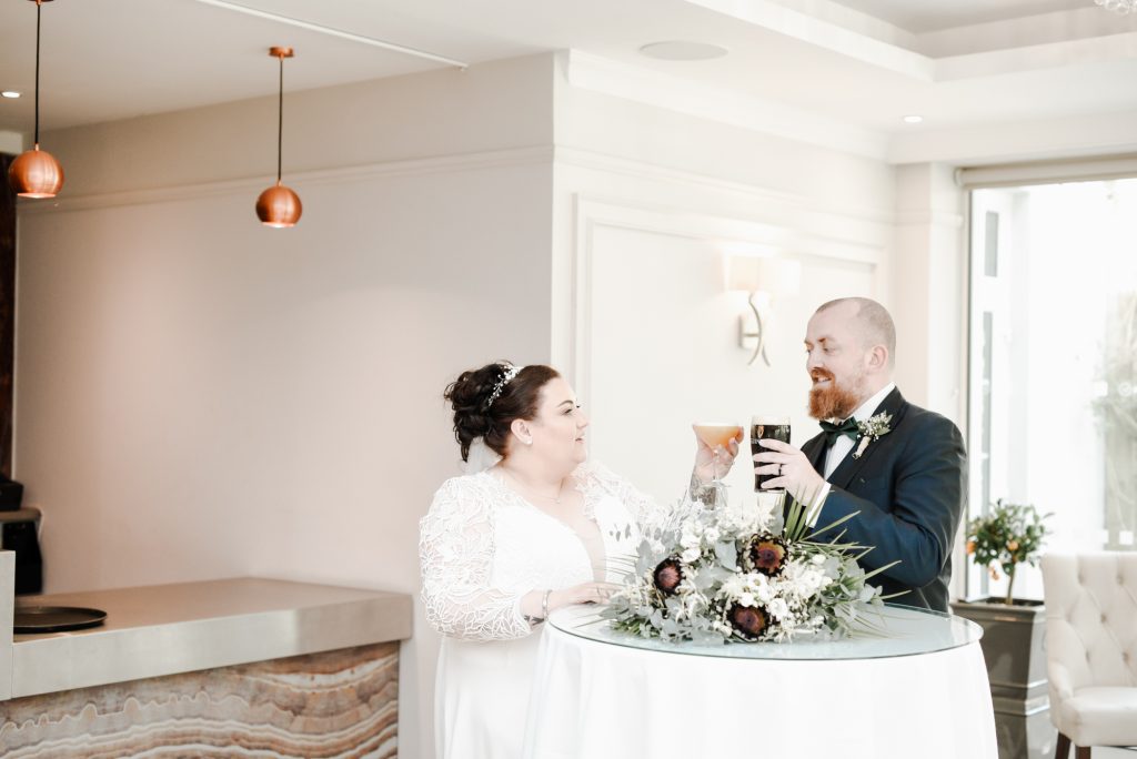 Bride and groom enjoying drinks during romantic wedding portraits in Northern Ireland Millbrook Lodge Ballynahinch